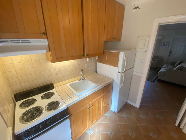 a kitchen with stainless steel appliances granite countertop a stove and a refrigerator