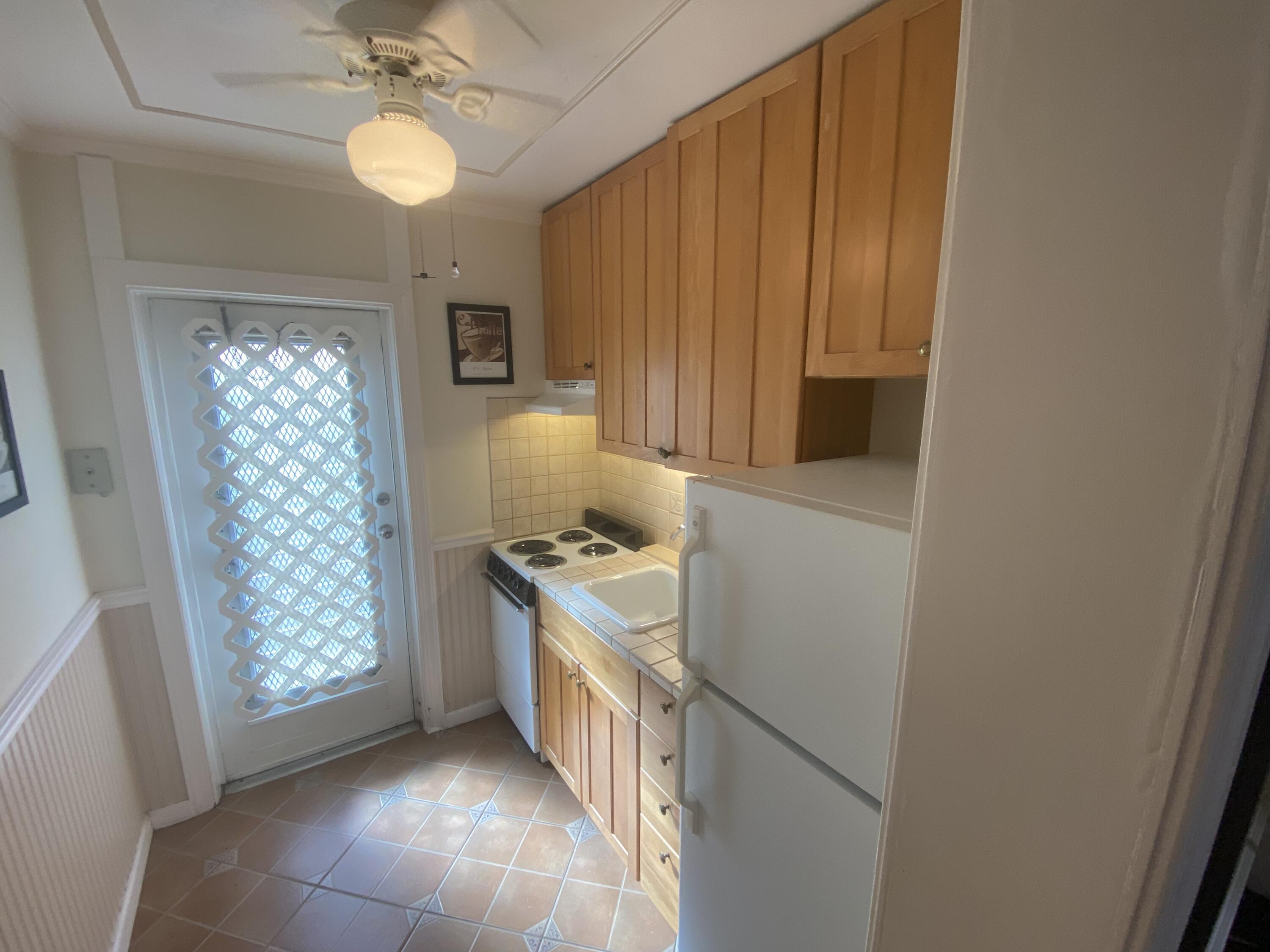 101 South Golfview Road, Unit 5 Lake Worth Beach, FL 33460 - Photo 14 of 17 a kitchen with stainless steel appliances granite countertop a stove and a refrigerator