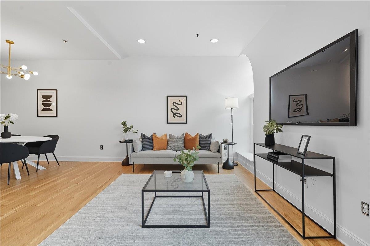 829 Washington Street, Unit 8 Hoboken, NJ 07030 - Photo 13 of 36 a living room with furniture and a wooden floor