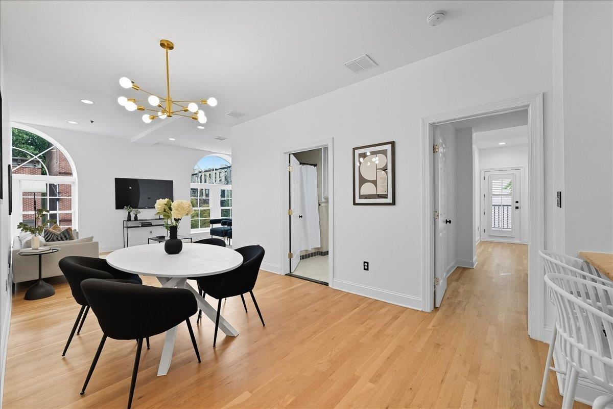829 Washington Street, Unit 8 Hoboken, NJ 07030 - Photo 15 of 36 a view of a dining room with furniture and wooden floor