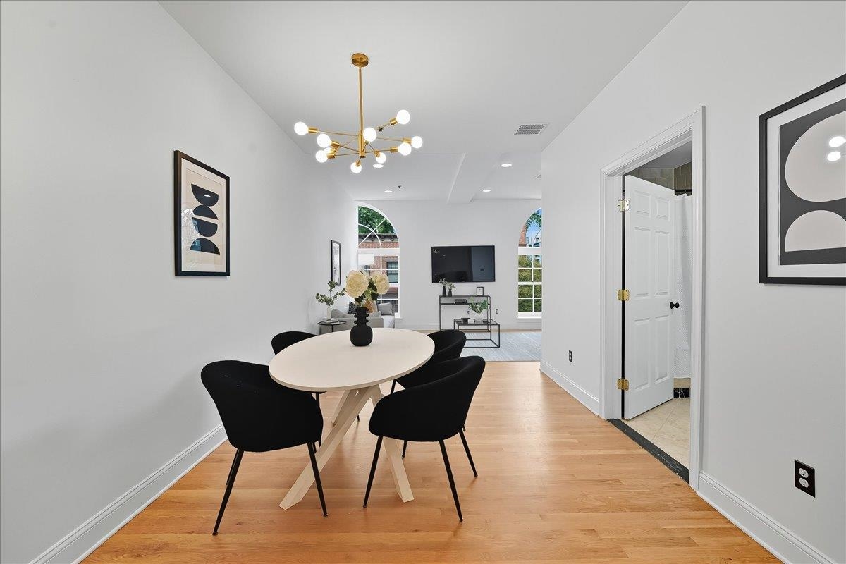 829 Washington Street, Unit 8 Hoboken, NJ 07030 - Photo 16 of 36 a view of a dining room with furniture a chandelier and wooden floor
