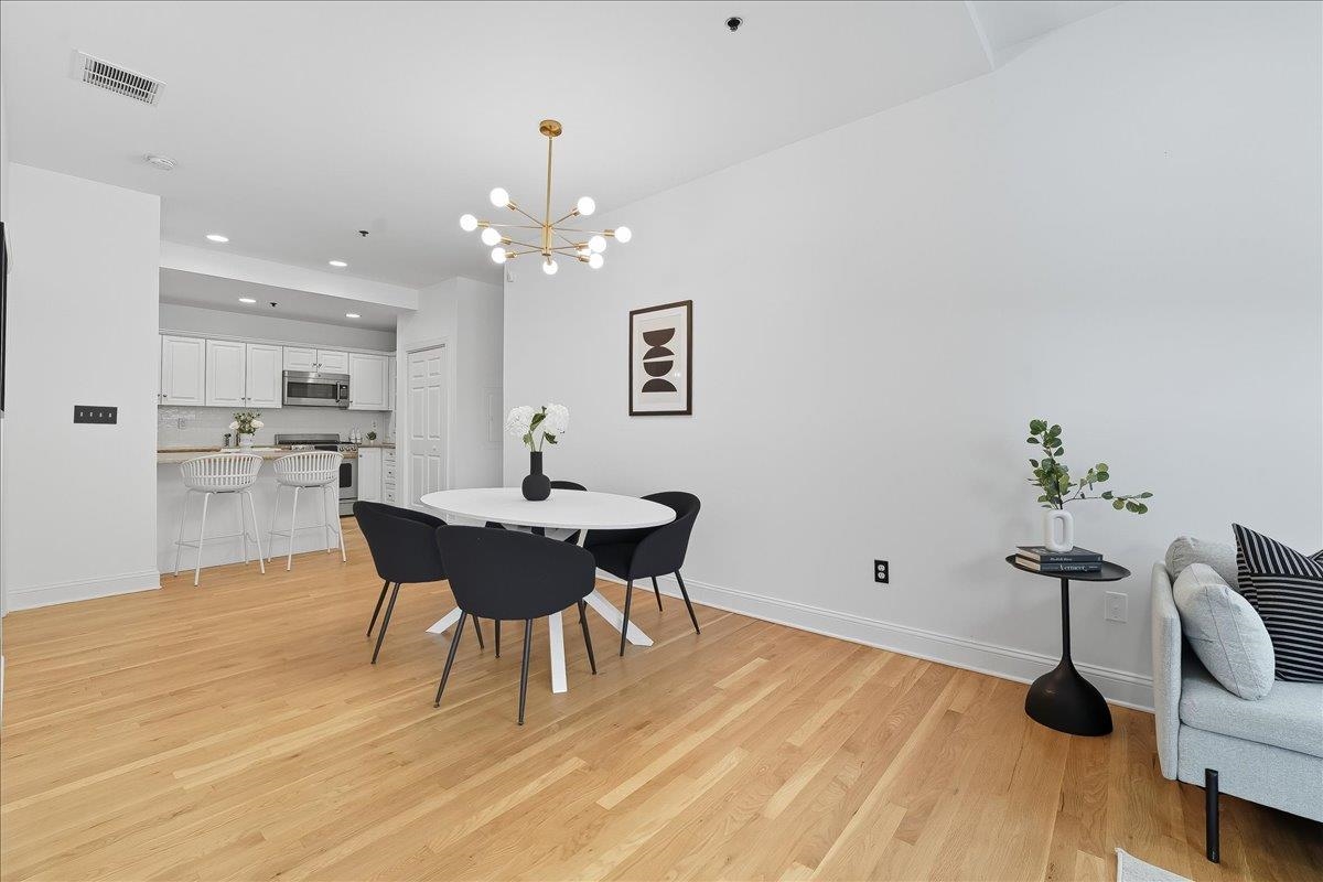 829 Washington Street, Unit 8 Hoboken, NJ 07030 - Photo 17 of 36 a view of a dining room with furniture and wooden floor