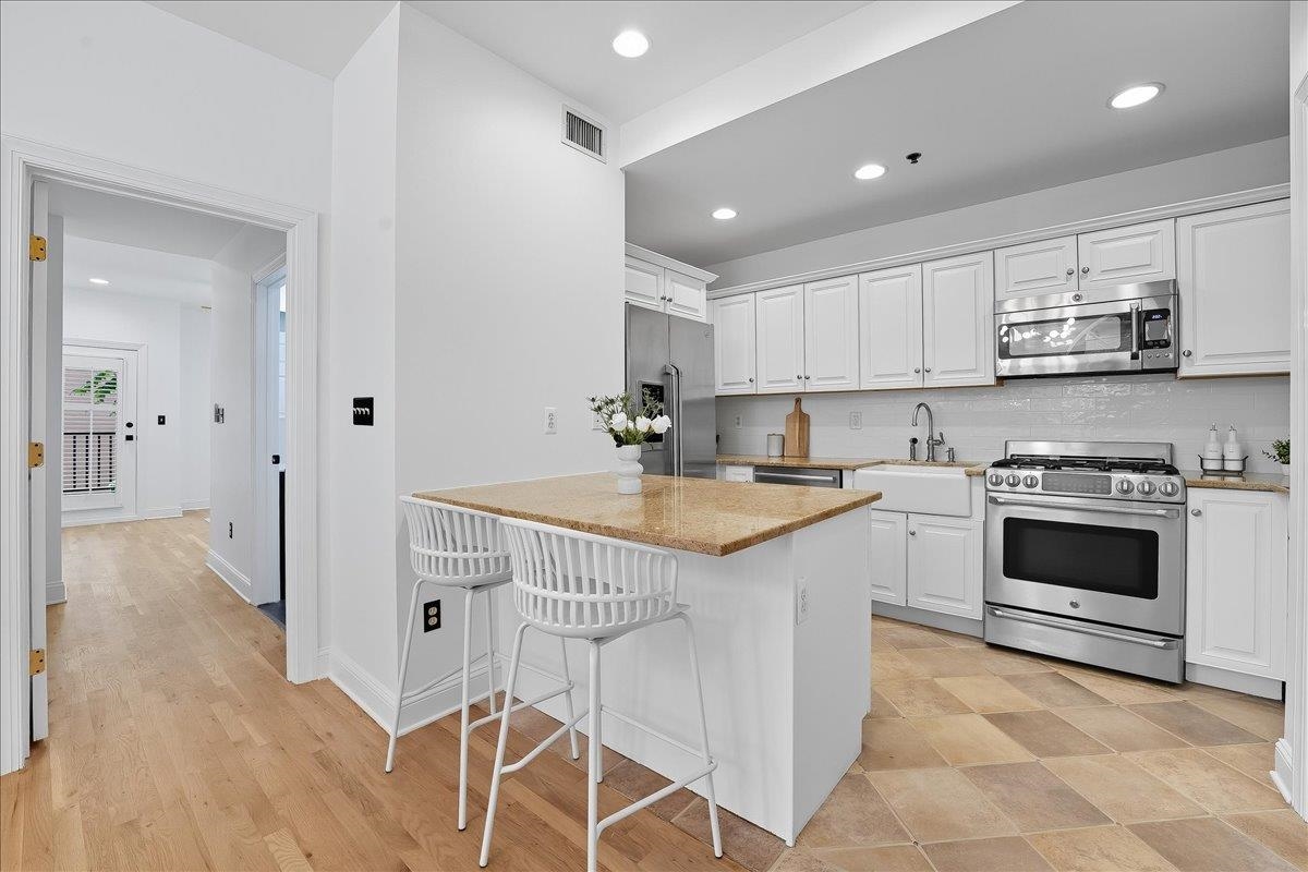 829 Washington Street, Unit 8 Hoboken, NJ 07030 - Photo 19 of 36 a kitchen with stainless steel appliances granite countertop a sink and cabinets