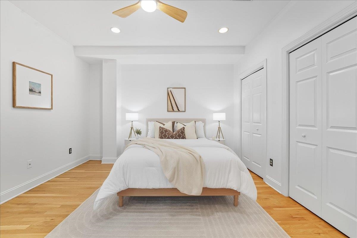 829 Washington Street, Unit 8 Hoboken, NJ 07030 - Photo 22 of 36 a spacious bedroom with a bed and a painting on the wall
