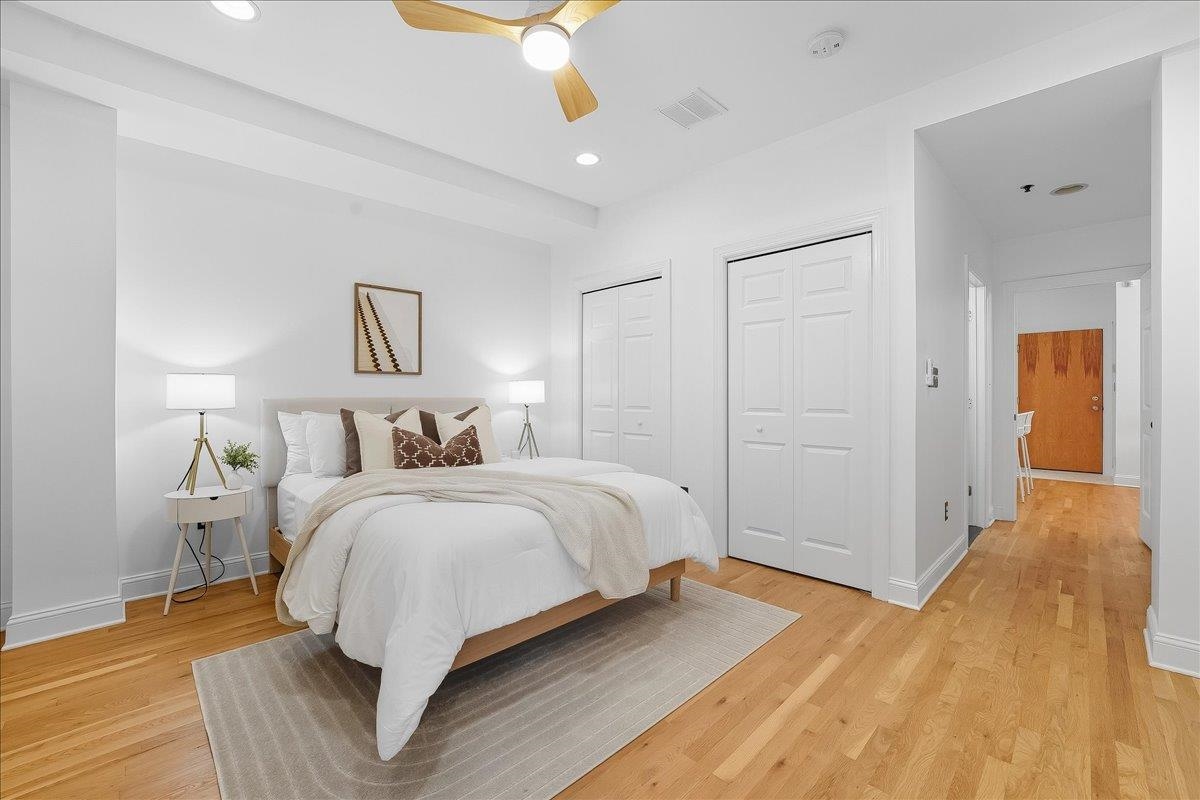 829 Washington Street, Unit 8 Hoboken, NJ 07030 - Photo 23 of 36 a spacious bedroom with a bed and a chandelier