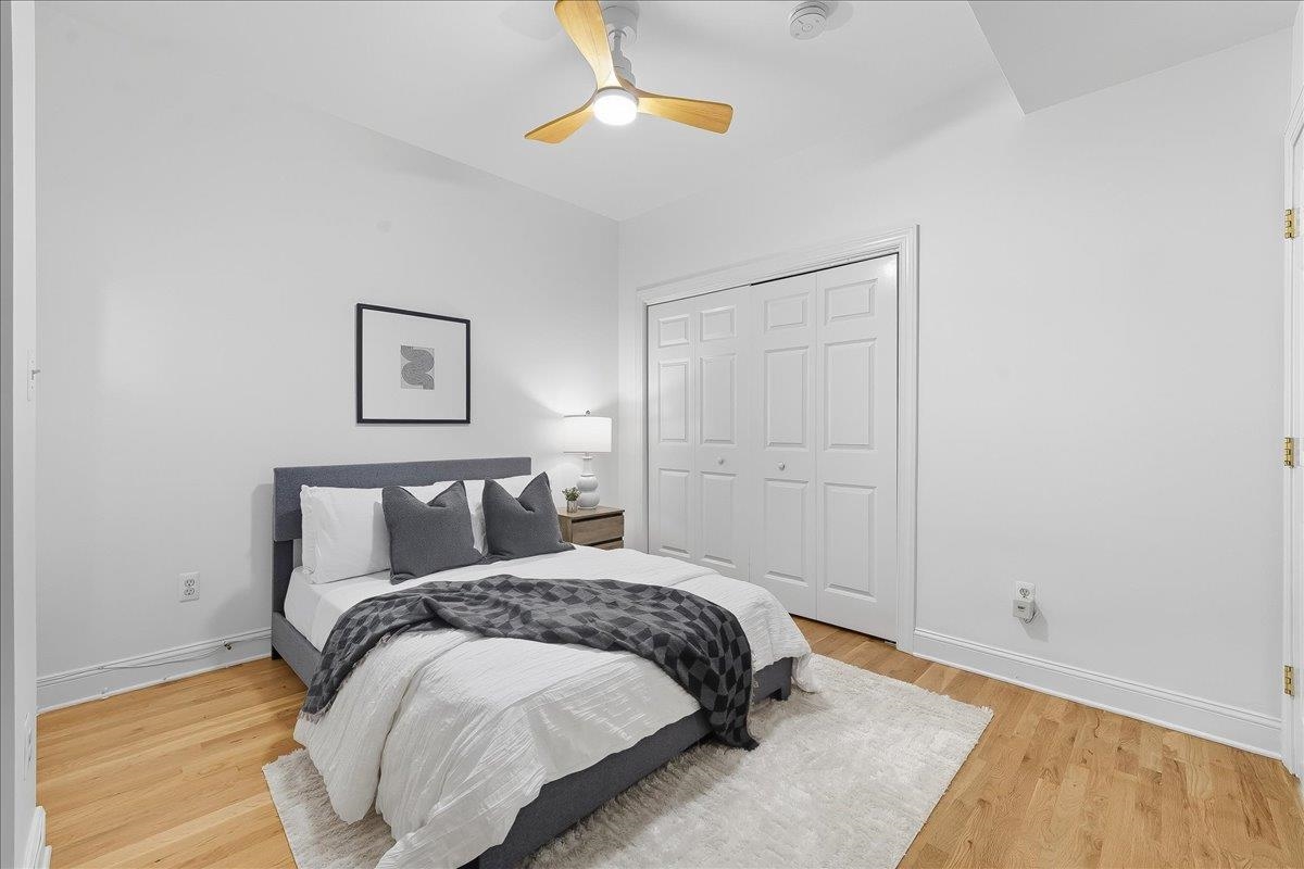 829 Washington Street, Unit 8 Hoboken, NJ 07030 - Photo 28 of 36 a bedroom with a bed and lamps
