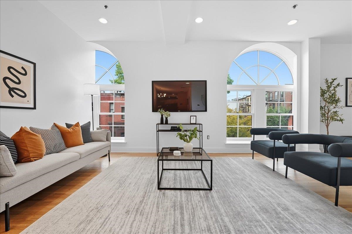 829 Washington Street, Unit 8 Hoboken, NJ 07030 - Photo 3 of 36 a living room with furniture and a flat screen tv
