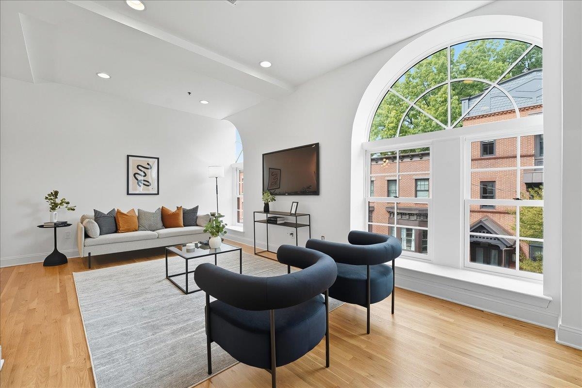 829 Washington Street, Unit 8 Hoboken, NJ 07030 - Photo 5 of 36 a living room with furniture a flat screen tv and a large window