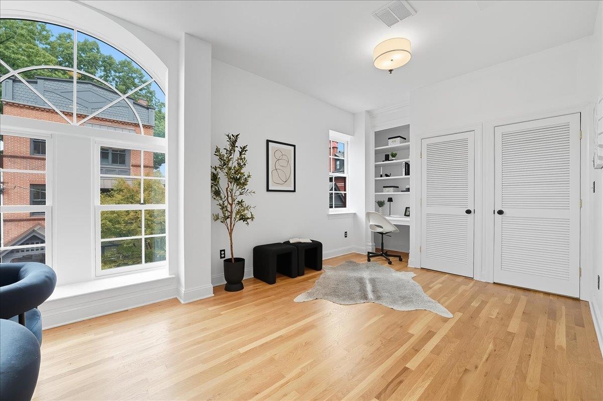829 Washington Street, Unit 8 Hoboken, NJ 07030 - Photo 7 of 36 a bedroom with a bed and a large window