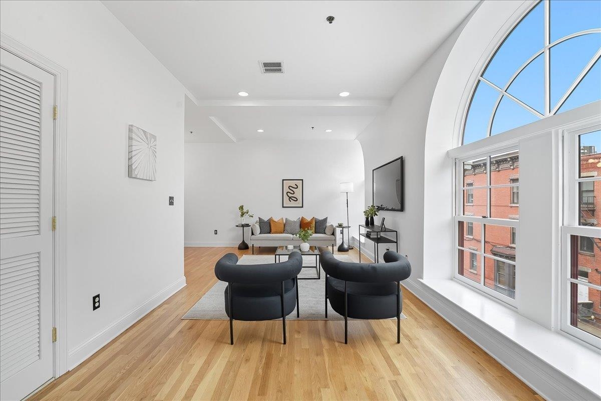829 Washington Street, Unit 8 Hoboken, NJ 07030 - Photo 8 of 36 a living room with furniture a window and wooden floor