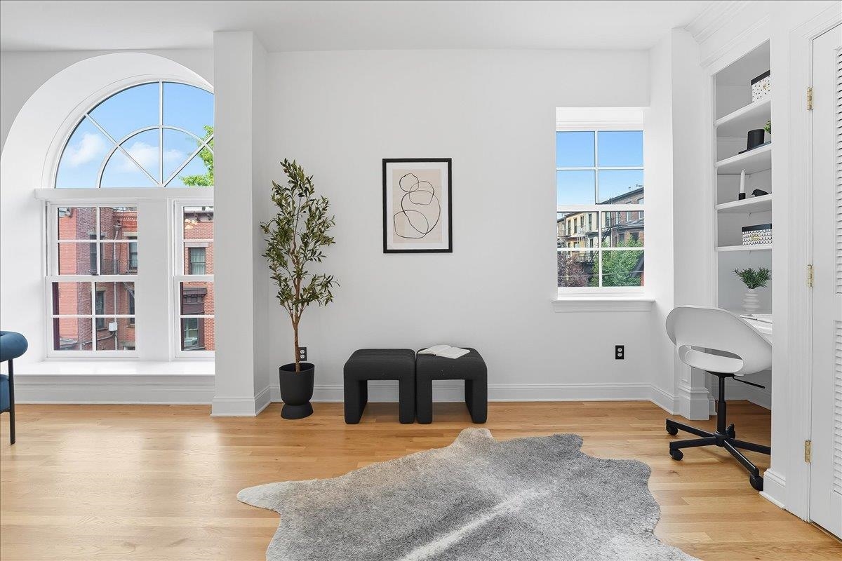 829 Washington Street, Unit 8 Hoboken, NJ 07030 - Photo 10 of 36 a view of a livingroom with furniture and a potted plant