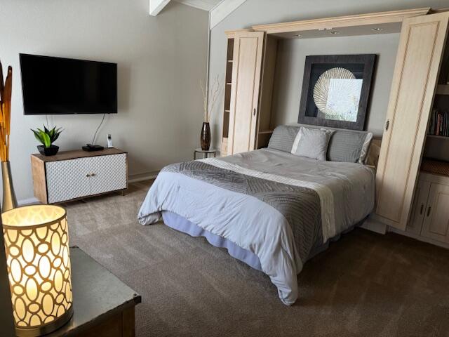 118 Racquet Club Drive South Rancho Mirage, CA 92270 - Photo 16 of 33 a spacious bedroom with a bed and a flat screen tv