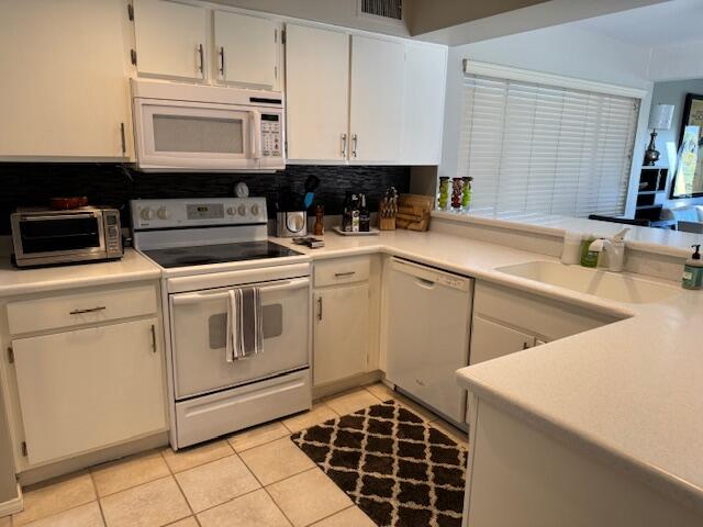 118 Racquet Club Drive South Rancho Mirage, CA 92270 - Photo 23 of 33 a kitchen with a sink a stove and cabinets