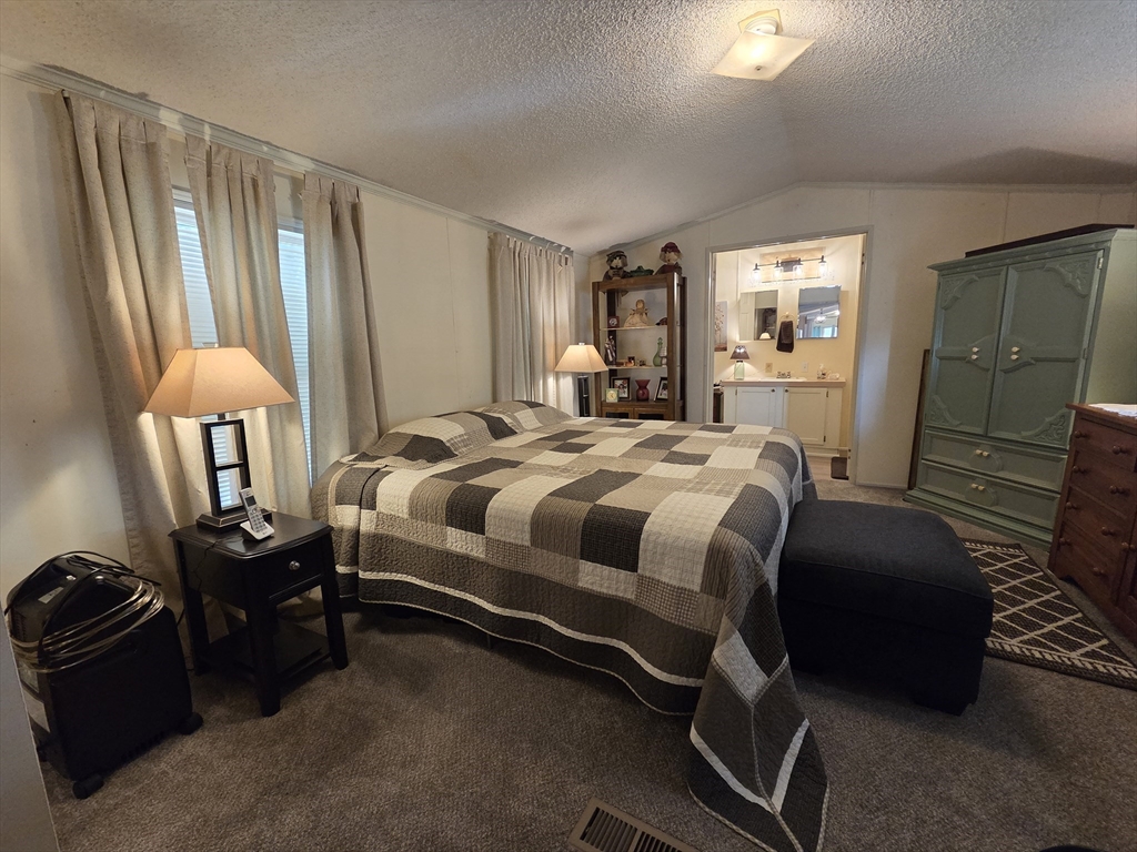 72 Holiday Circle Chicopee, MA 01020 - Photo 11 of 16 a bedroom with a bed chair and double door