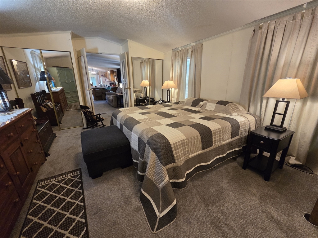 72 Holiday Circle Chicopee, MA 01020 - Photo 12 of 16 a bed room with a bed and a lamp