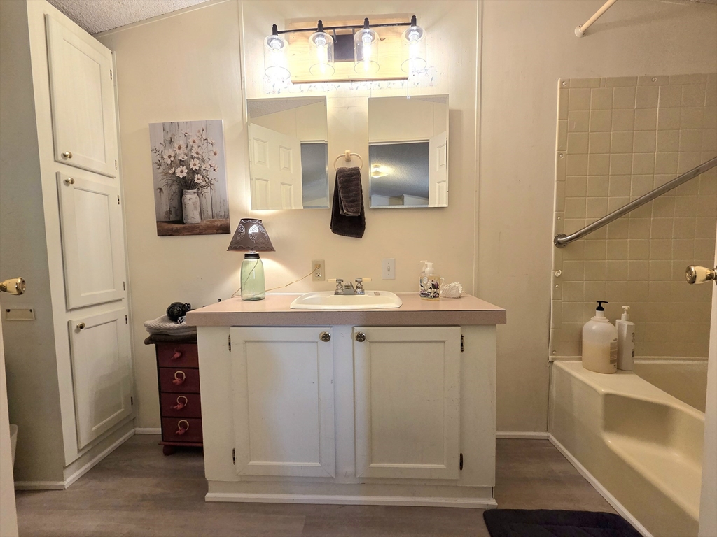 72 Holiday Circle Chicopee, MA 01020 - Photo 13 of 16 a bathroom with a double vanity sink and mirror