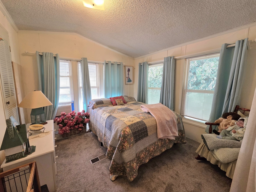 72 Holiday Circle Chicopee, MA 01020 - Photo 5 of 16 a spacious bedroom with a bed and a couch