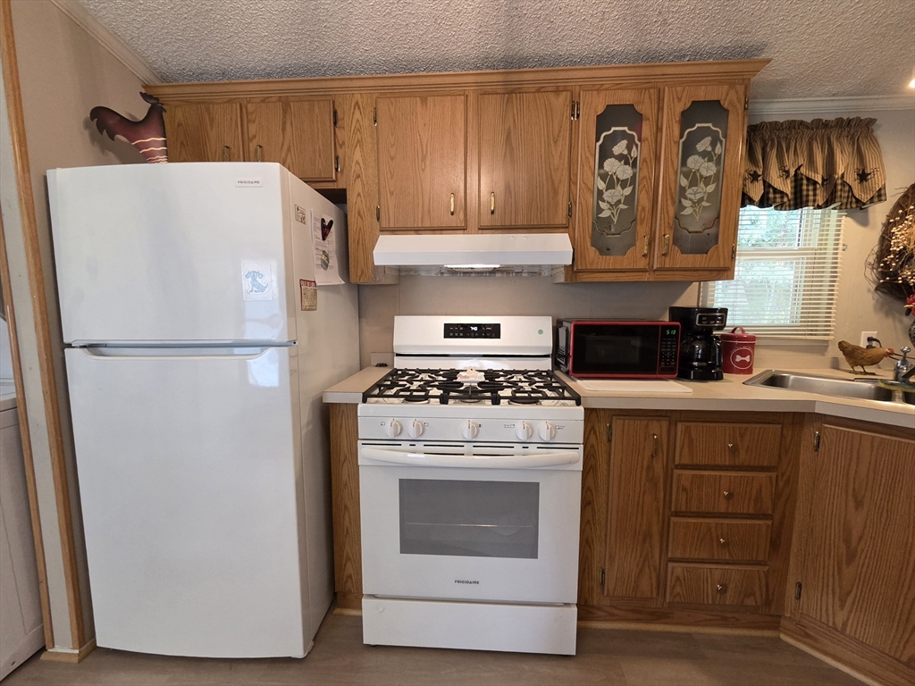72 Holiday Circle Chicopee, MA 01020 - Photo 7 of 16 a white refrigerator freezer sitting inside of a kitchen