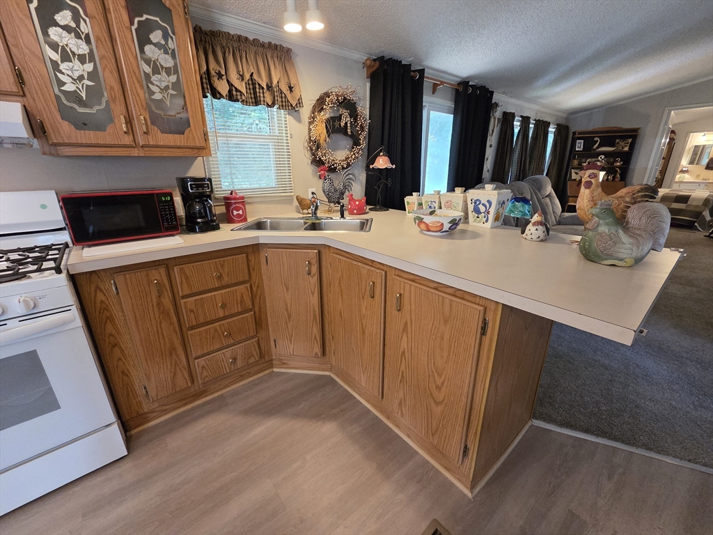 72 Holiday Circle Chicopee, MA 01020 - Photo 8 of 16 a kitchen with a sink cabinets and a stove top oven