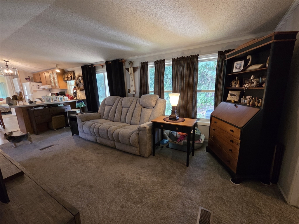 72 Holiday Circle Chicopee, MA 01020 - Photo 10 of 16 a living room with furniture and a flat screen tv