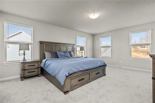 a spacious bedroom with a bed and window