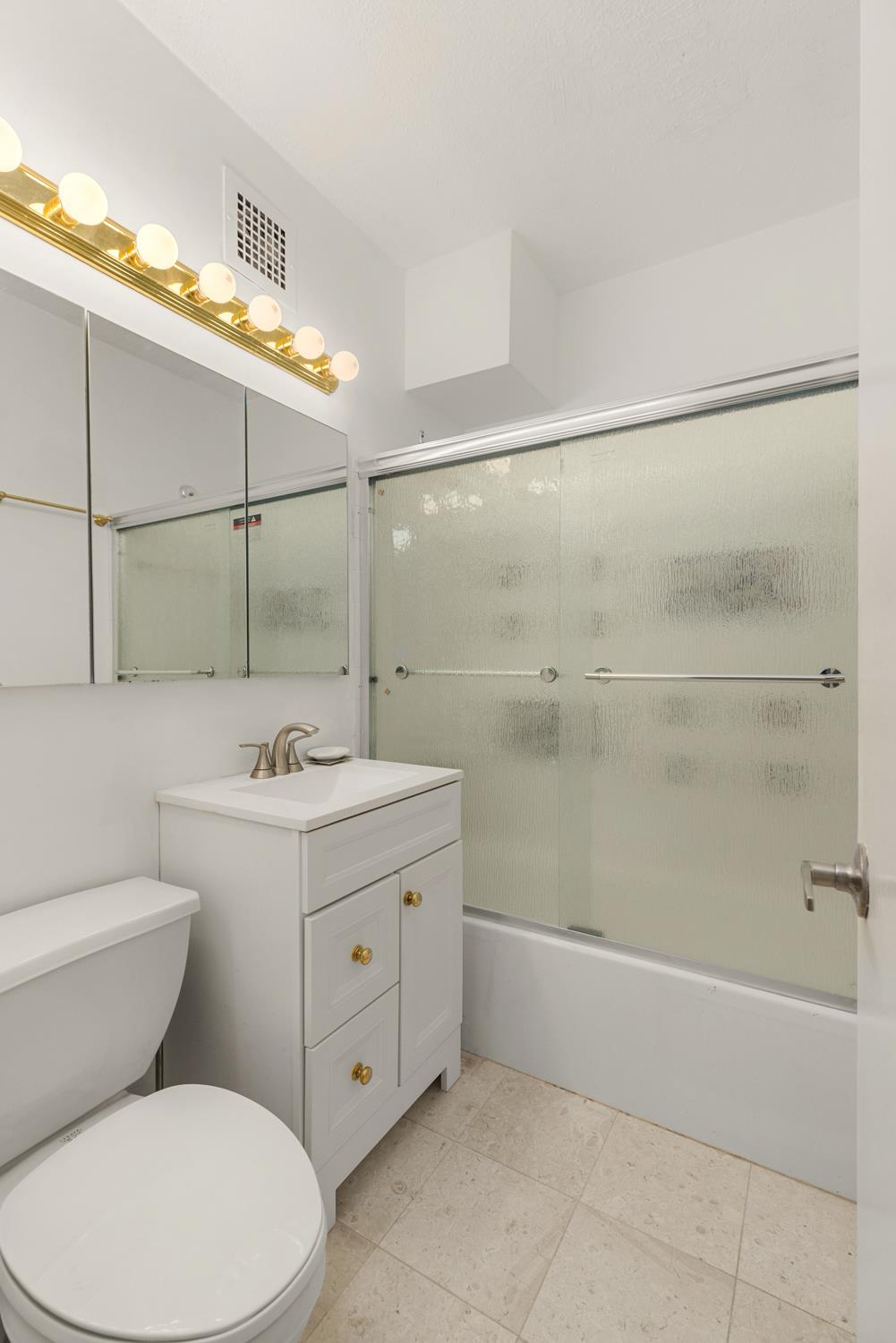 130 Water Street, Unit 3F Manhattan, NY 10005 - Photo 6 of 7 a bathroom with a toilet sink and shower