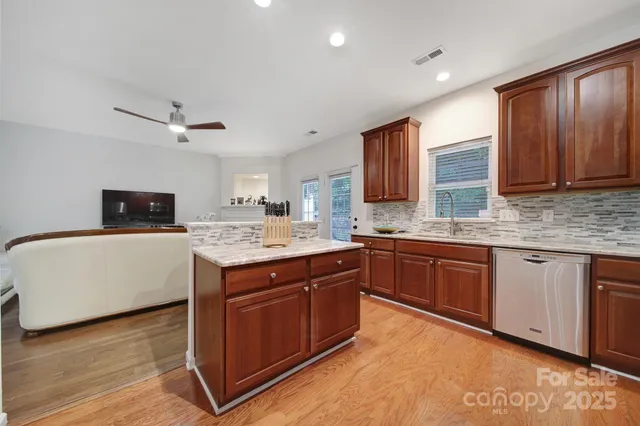 a kitchen with a sink cabinets and wooden floor