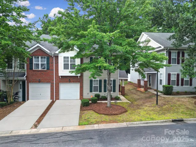 a front view of house with yard and trees