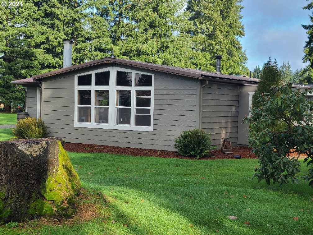 a view of a house with a yard and plants