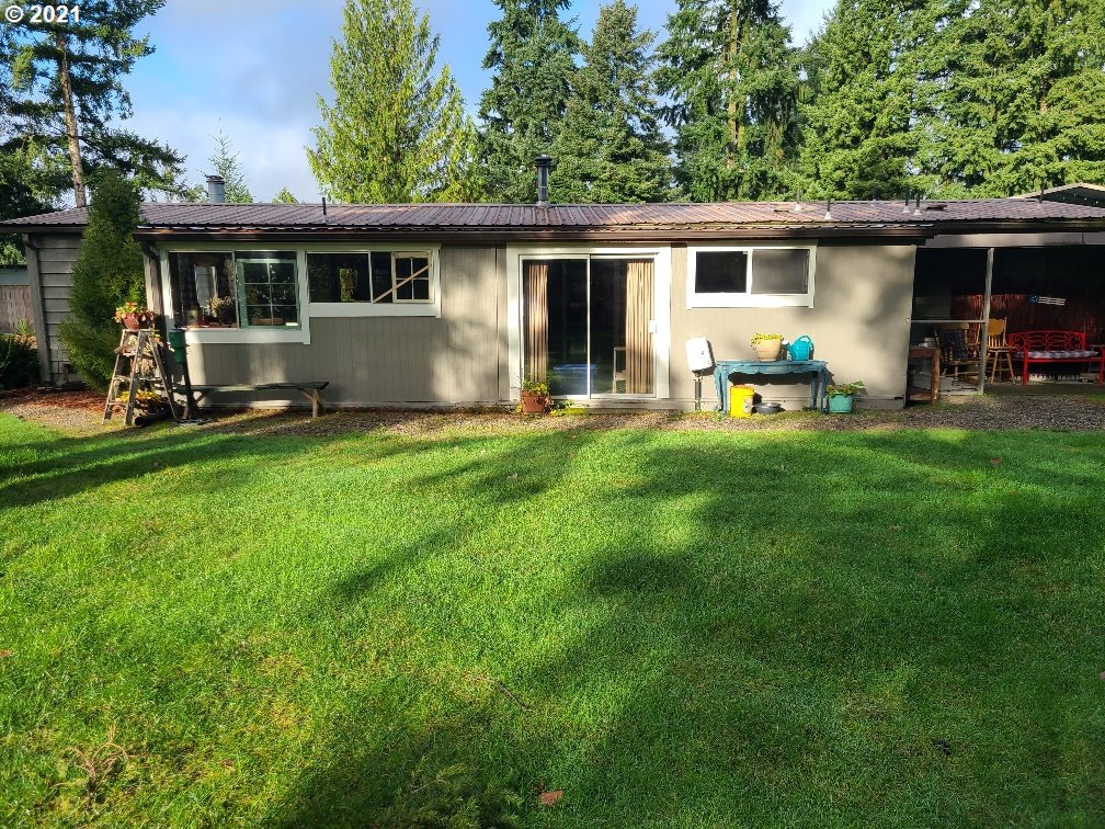 9024 173rd Avenue Southwest Rochester, WA 98579 - Photo 3 of 16 a view of a house with backyard sitting area and garden