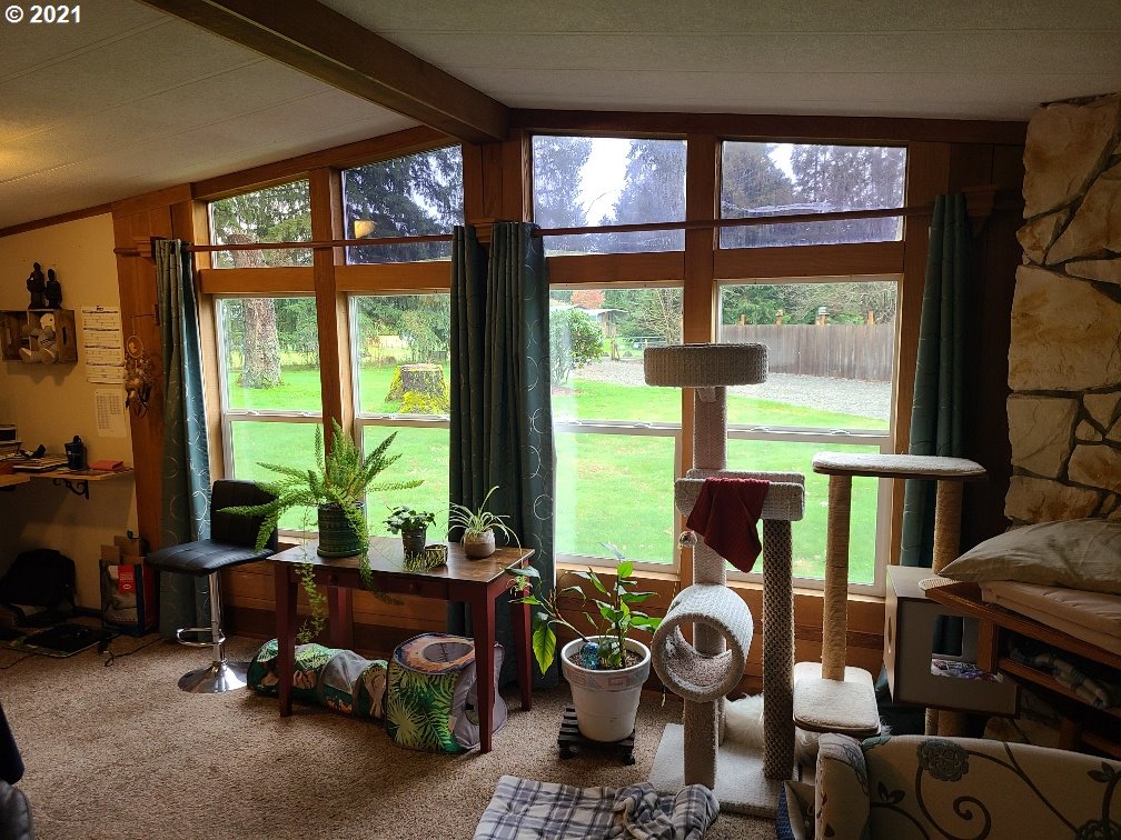 9024 173rd Avenue Southwest Rochester, WA 98579 - Photo 4 of 16 a living room filled with furniture and a floor to ceiling window