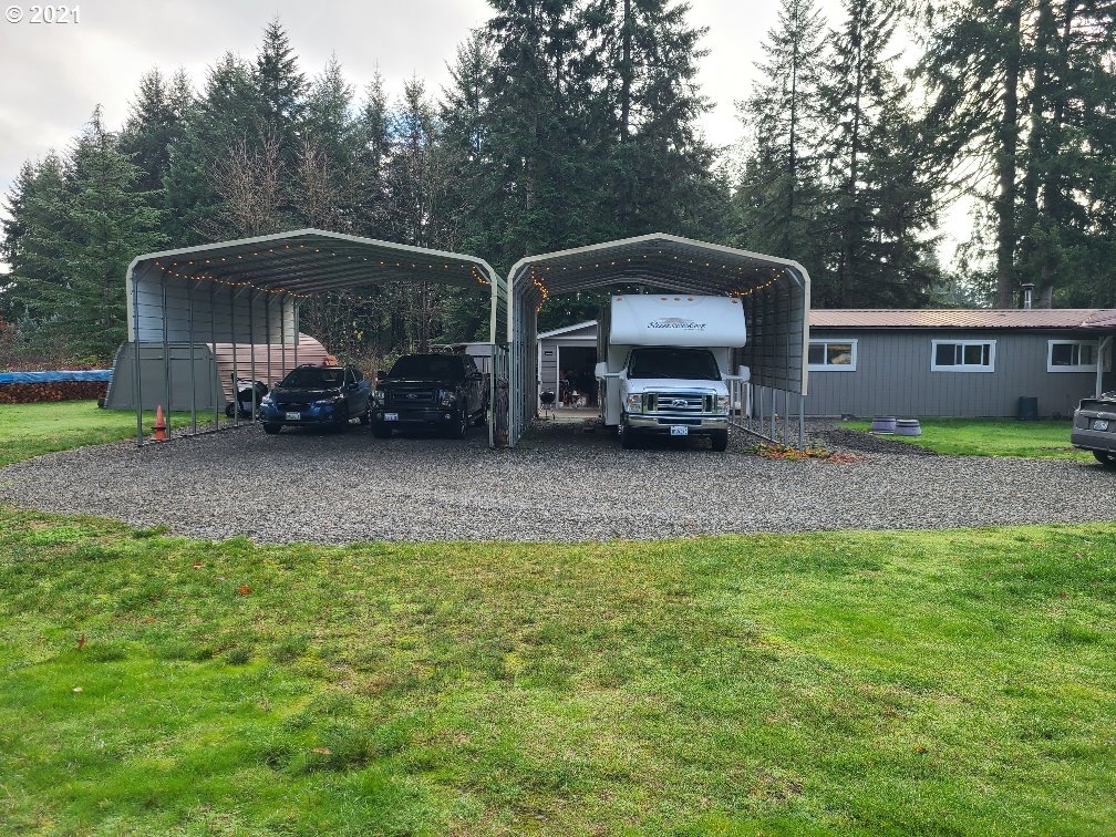 9024 173rd Avenue Southwest Rochester, WA 98579 - Photo 10 of 16 a view of a house with a car parked in it