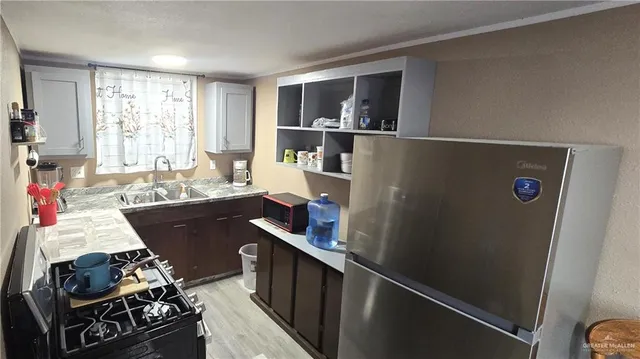 a view of a kitchen with workspace and a window
