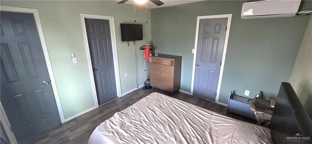 a bedroom with a bed and a mirror