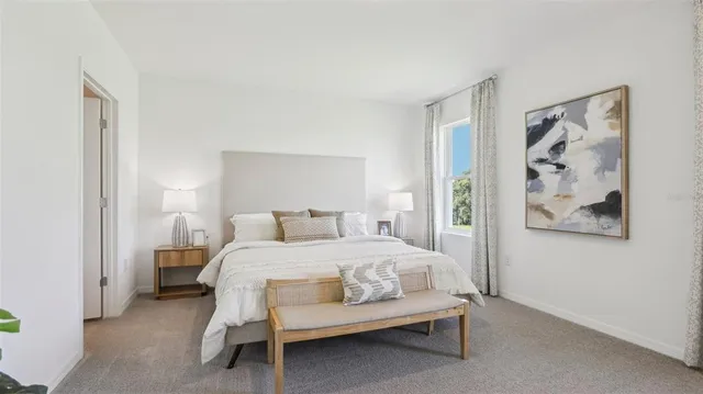 a bedroom with a bed and wall painting