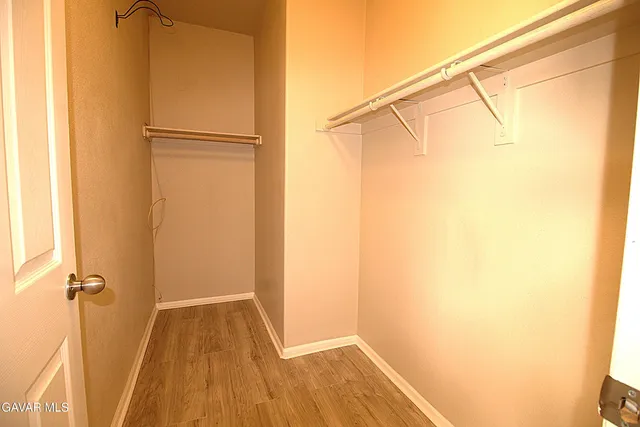 a view of a room with wooden floor and a window