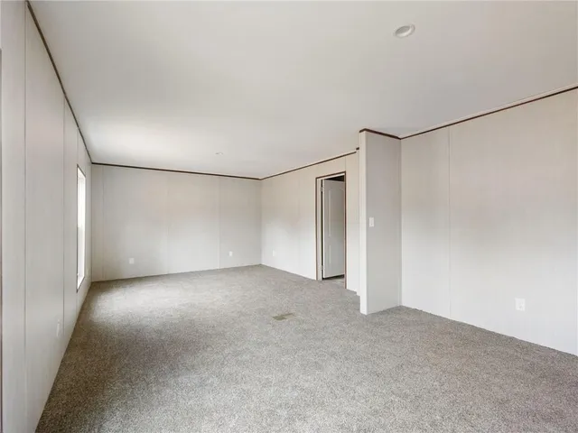 a view of a big room with closet and windows