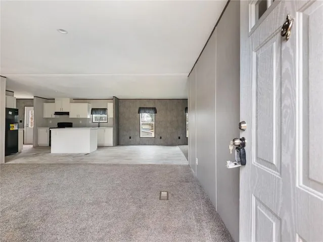 a view of a kitchen with a refrigerator and a window