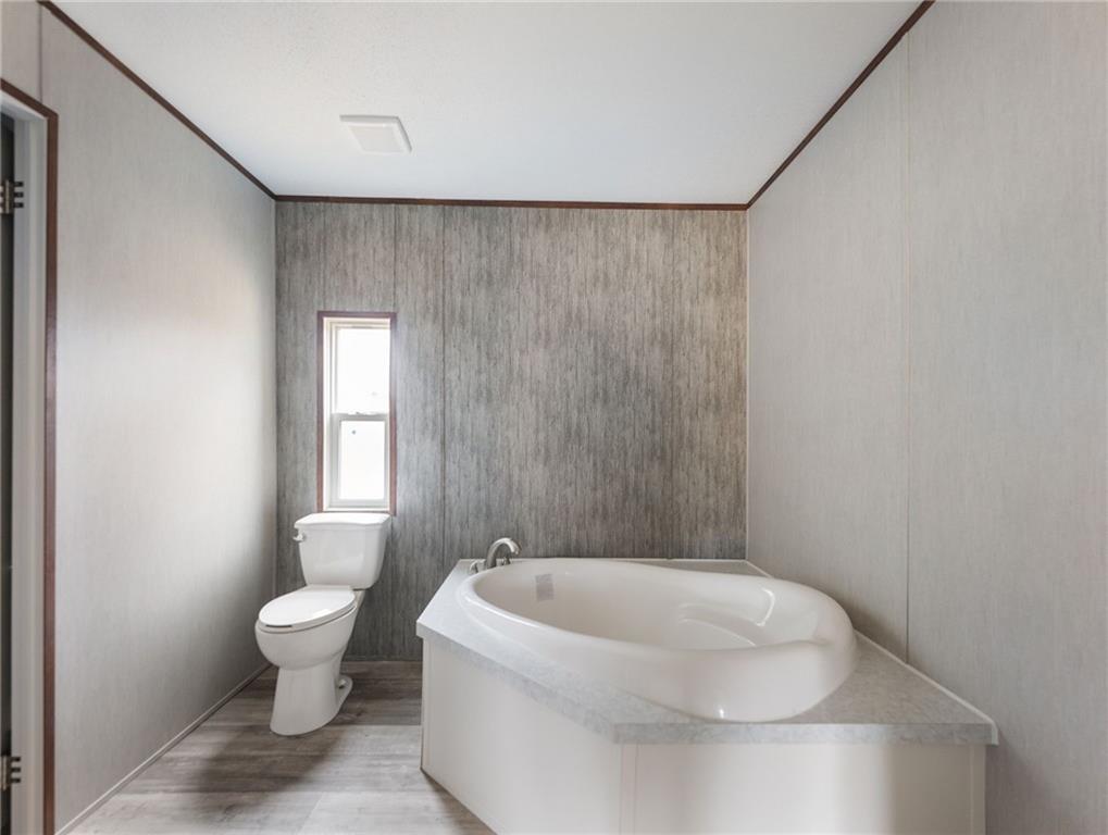 5226 Bogus Road Commerce, GA 30530 - Photo 21 of 41 a white toilet sitting next to a bathroom sink