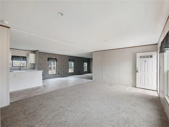 a view of a big room with closet and windows
