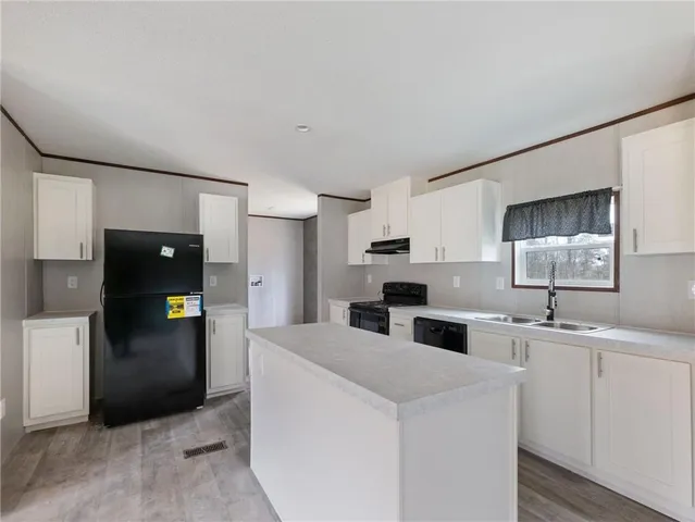 a kitchen with stainless steel appliances a refrigerator sink and stove