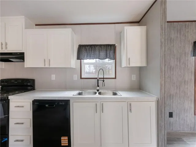 a kitchen with a sink cabinets and window