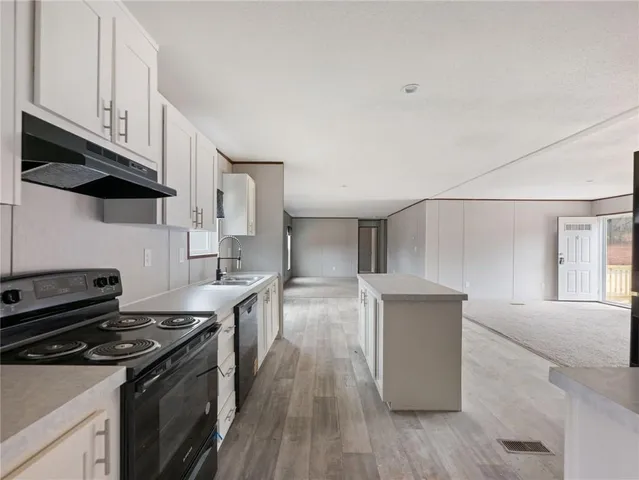 a kitchen with stainless steel appliances granite countertop a stove and a sink