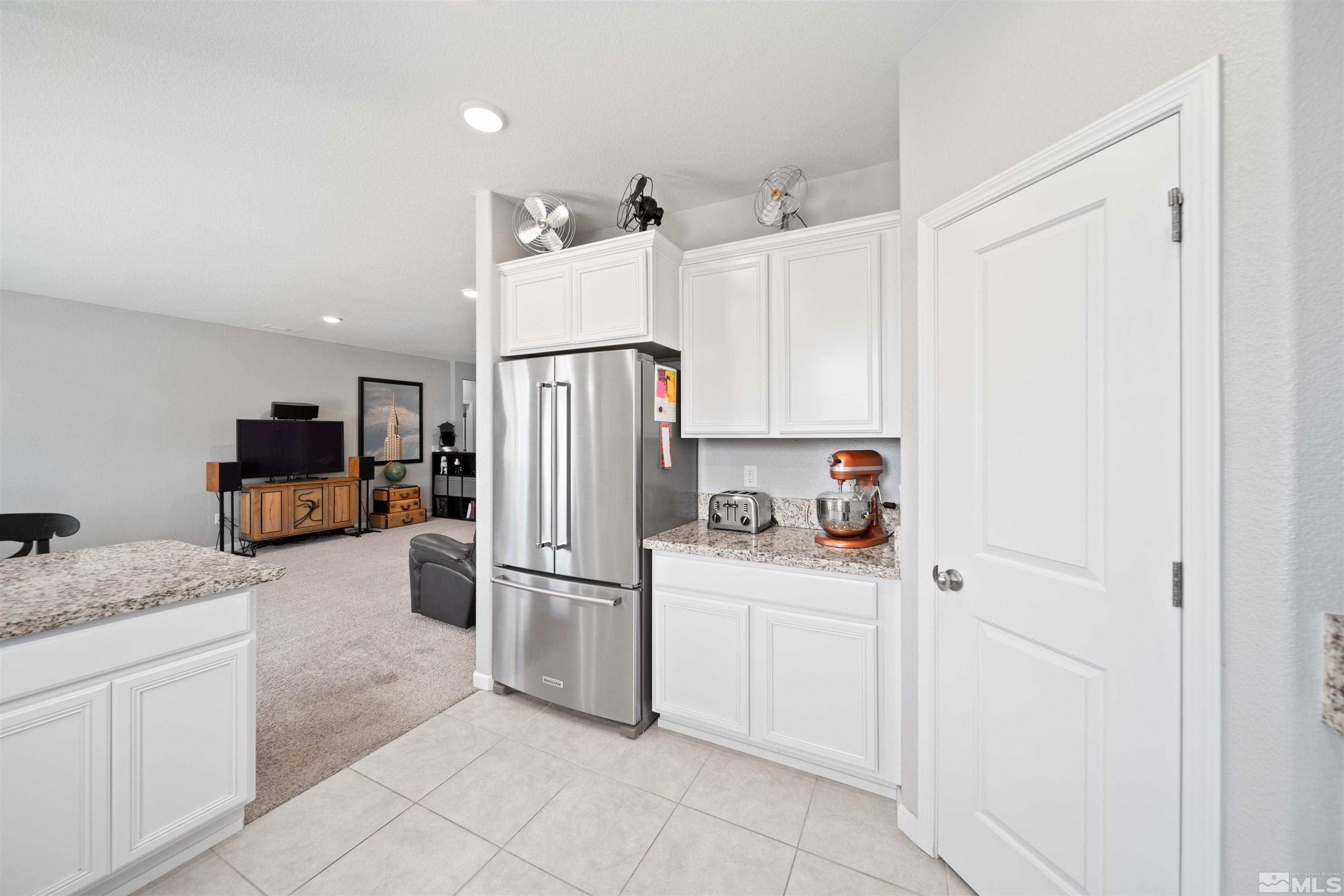 449 Scenic Ridge Drive Reno, NV 89506 - Photo 6 of 22 a kitchen with white cabinets and refrigerator