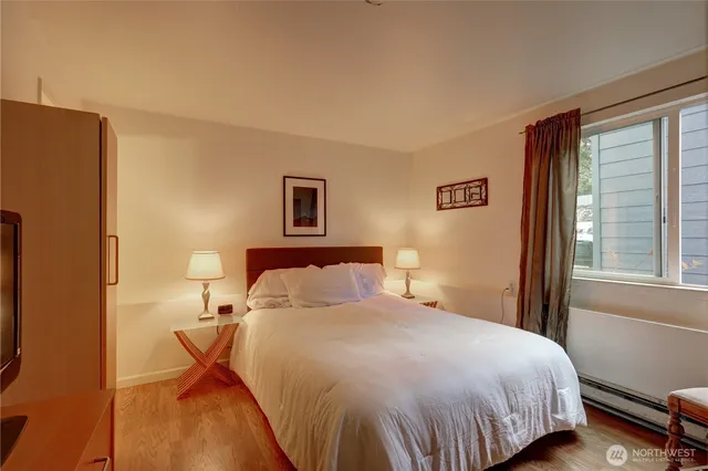 a bedroom with a bed and a night stand