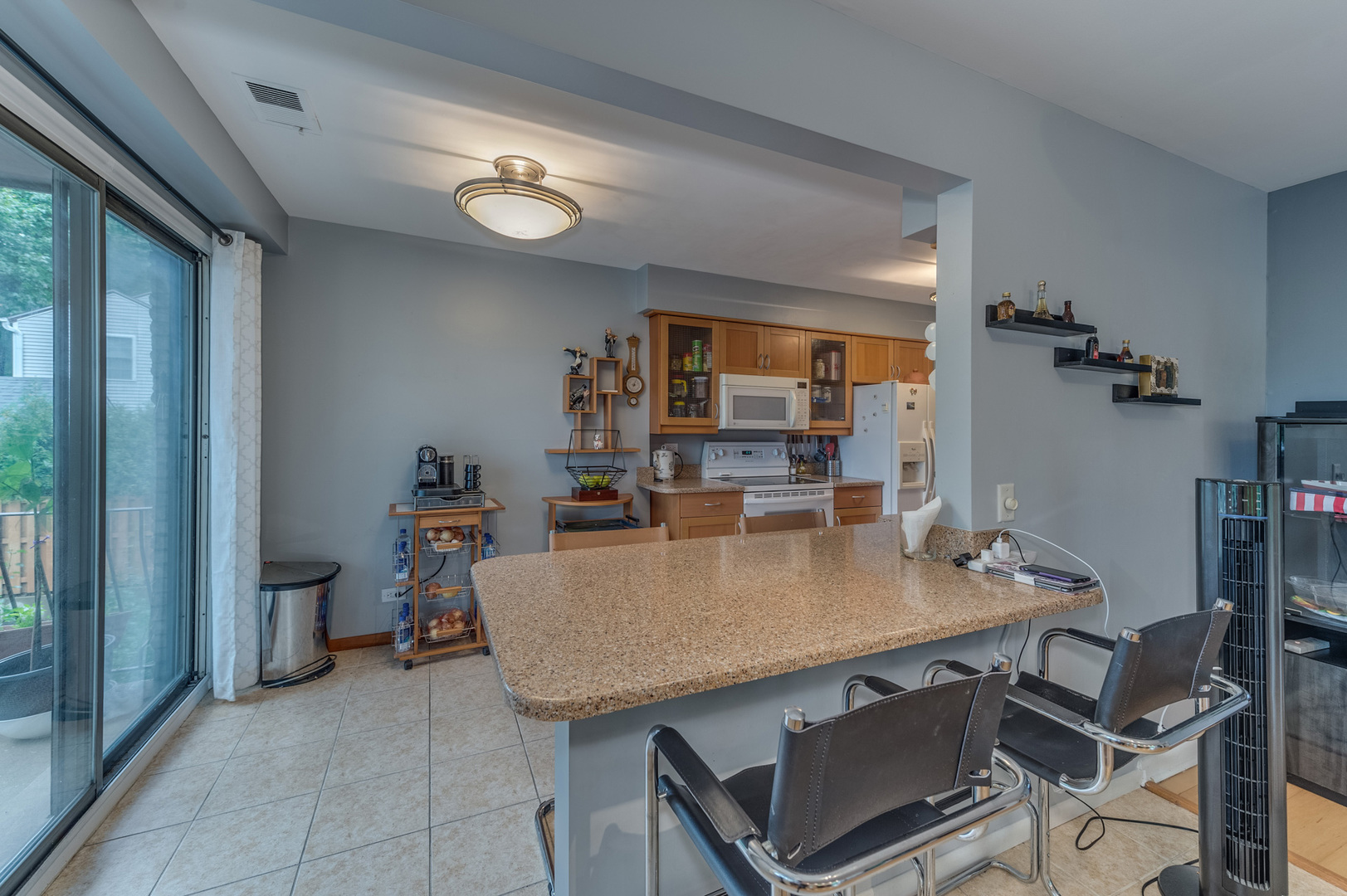 110 Green Bay Road, Unit 101 Glencoe, IL 60022 - Photo 13 of 31 a view of a dining room with furniture and a chandelier