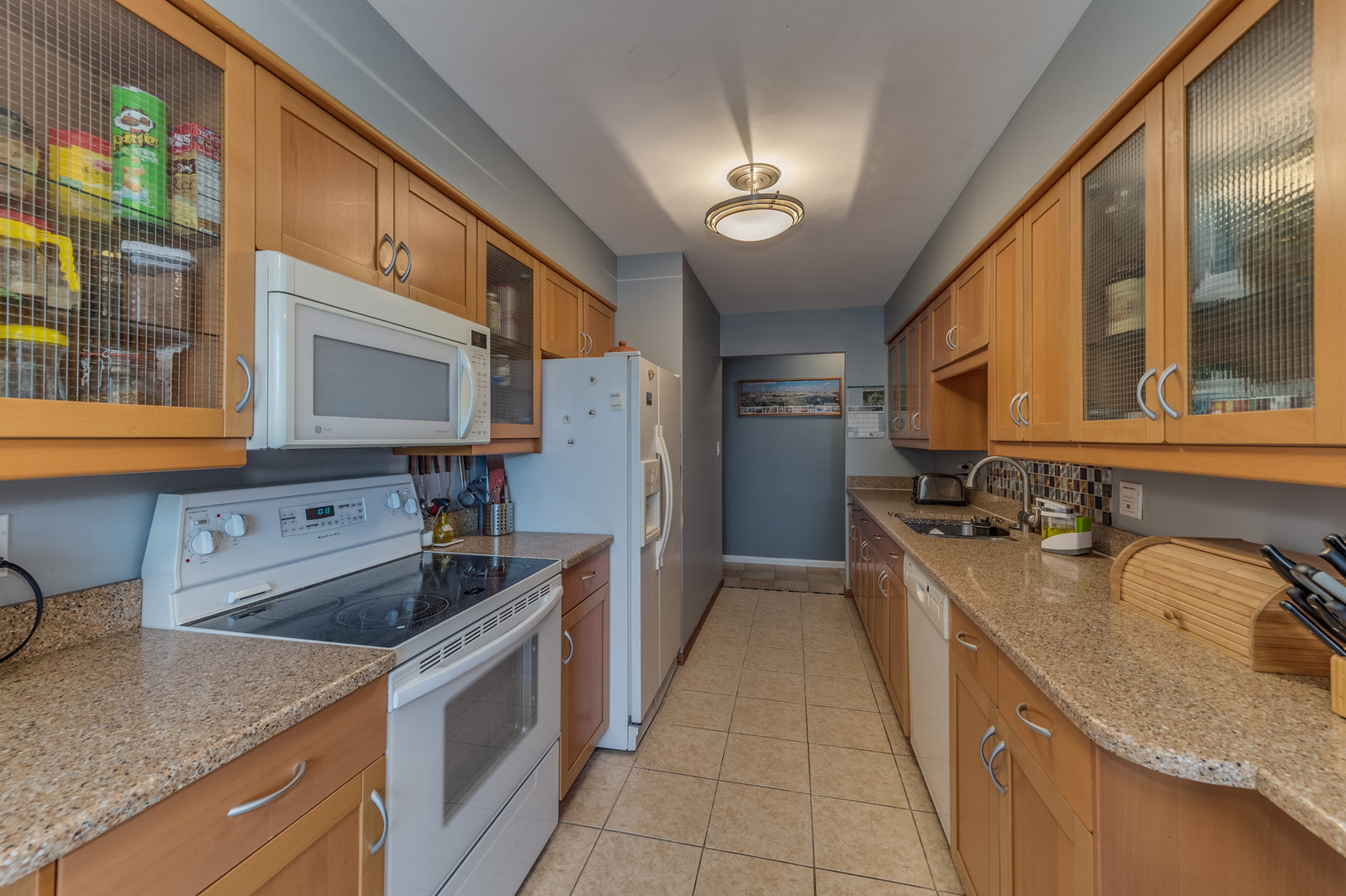 110 Green Bay Road, Unit 101 Glencoe, IL 60022 - Photo 15 of 31 a kitchen with granite countertop a sink stove and refrigerator