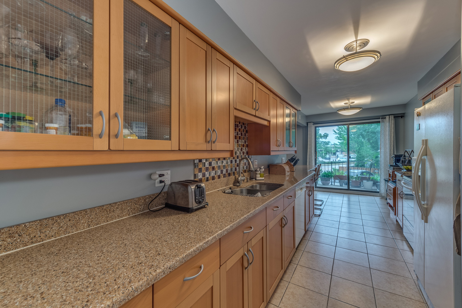 110 Green Bay Road, Unit 101 Glencoe, IL 60022 - Photo 16 of 31 a kitchen with stainless steel appliances granite countertop a sink and cabinets