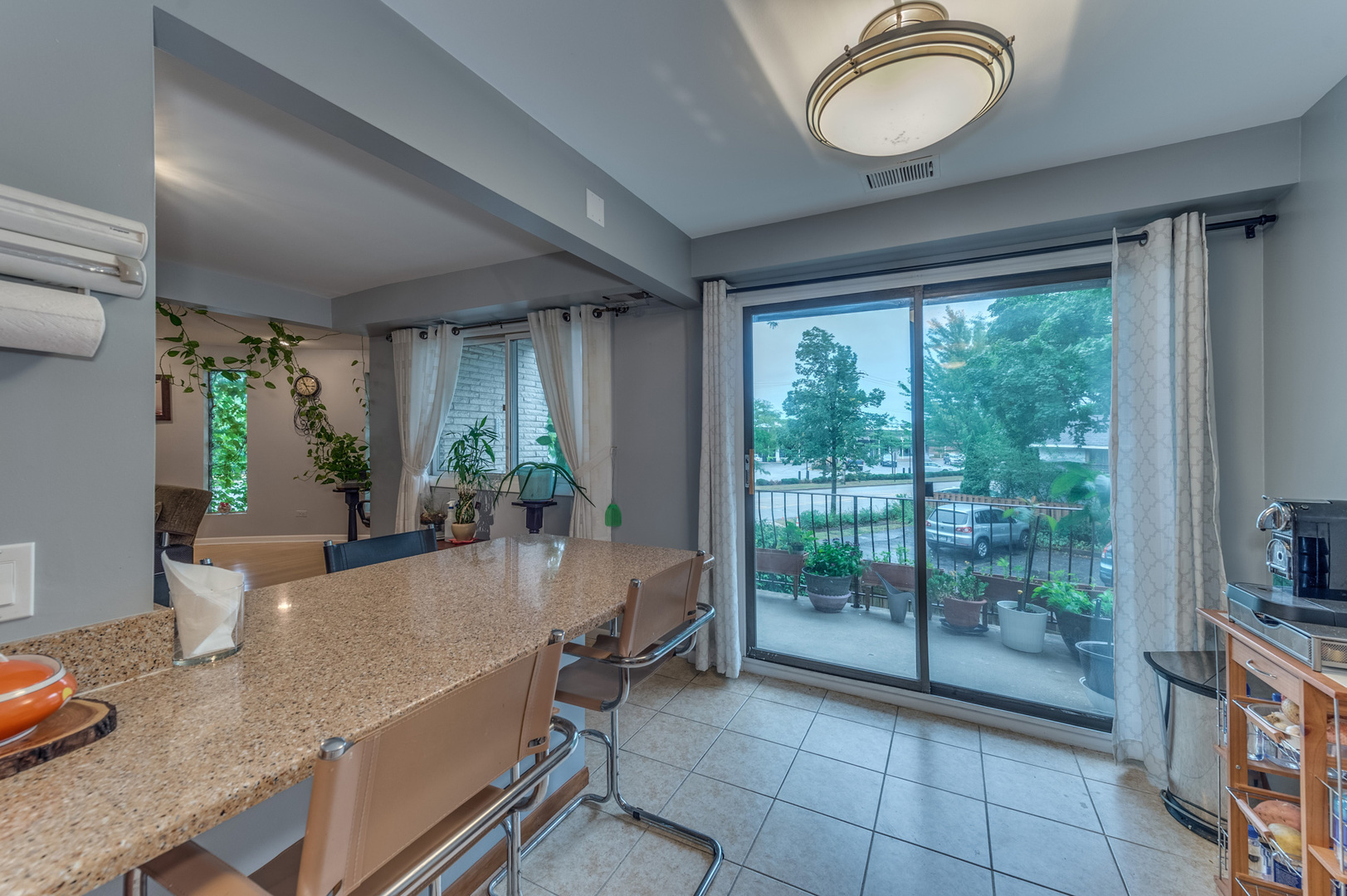 110 Green Bay Road, Unit 101 Glencoe, IL 60022 - Photo 17 of 31 a dining room with furniture and a floor to ceiling window