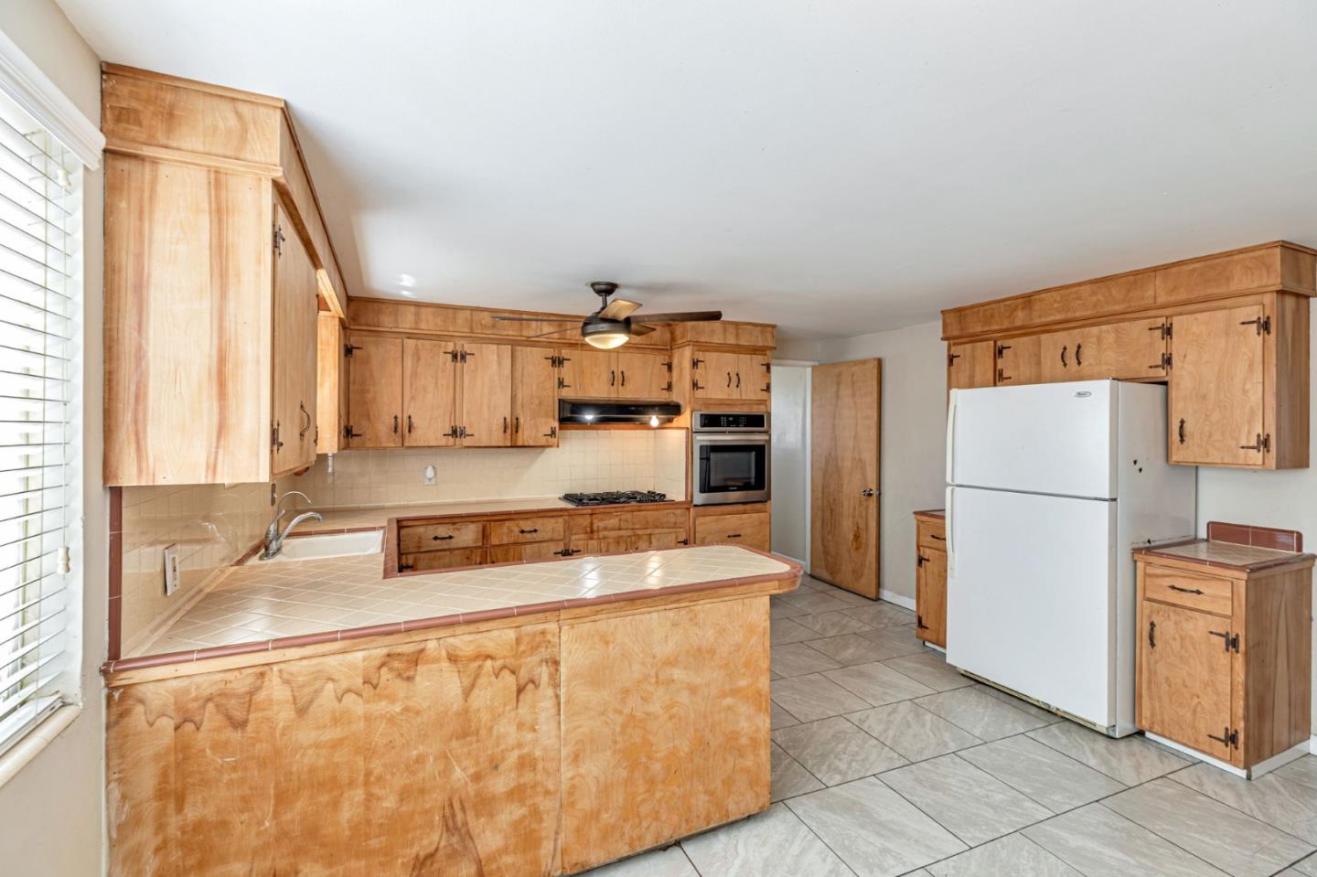2718 Ferguson Road Gilroy, CA 95020 - Photo 23 of 94 a kitchen with stainless steel appliances granite countertop a refrigerator a stove and a sink with cabinets